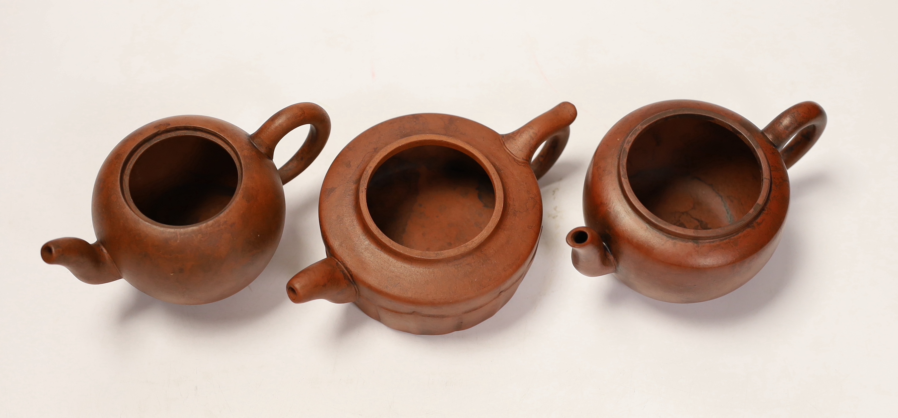 Three Chinese Yixing terracotta teapots, tallest 9cm